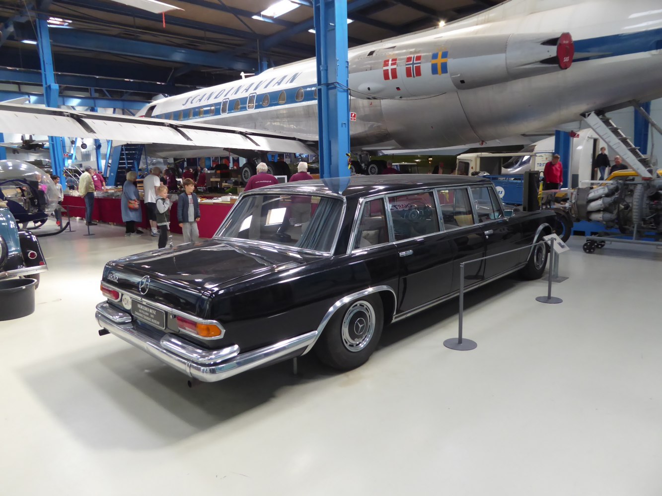 Extended luxury sedan with chrome trim and covered rear wheel.