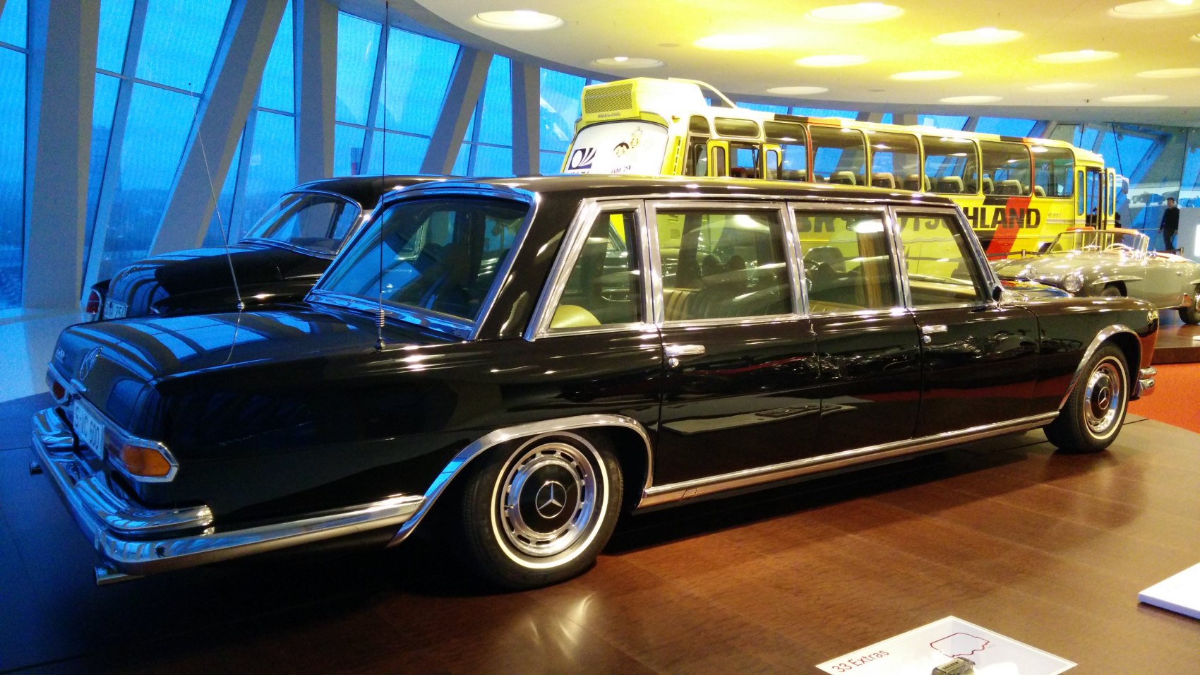Elegant long limousine with chrome trim and multiple windows.