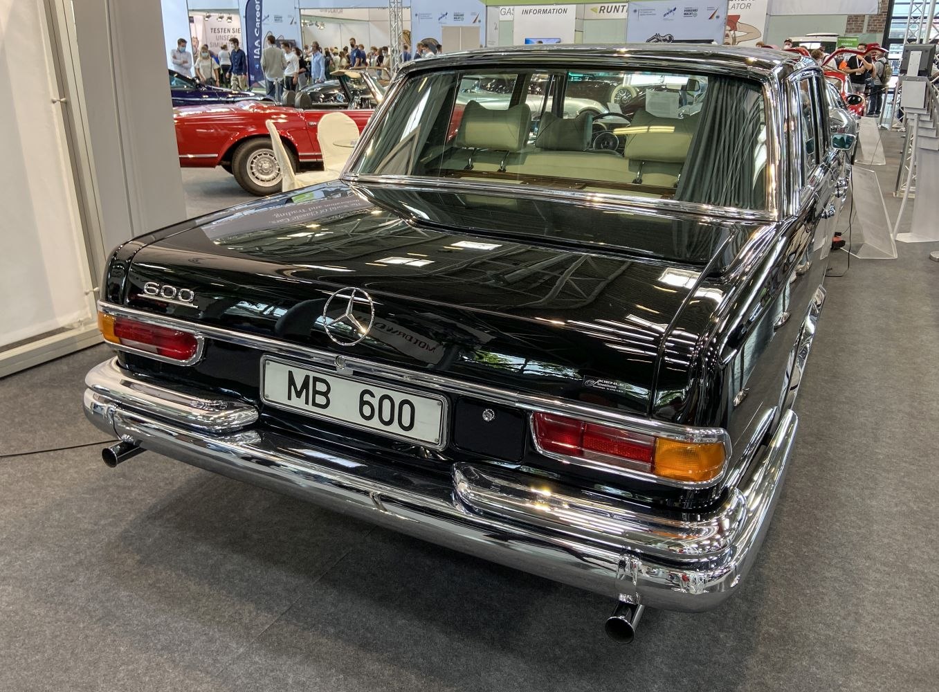 Rear view of a vintage luxury sedan with chrome bumper and dual exhausts