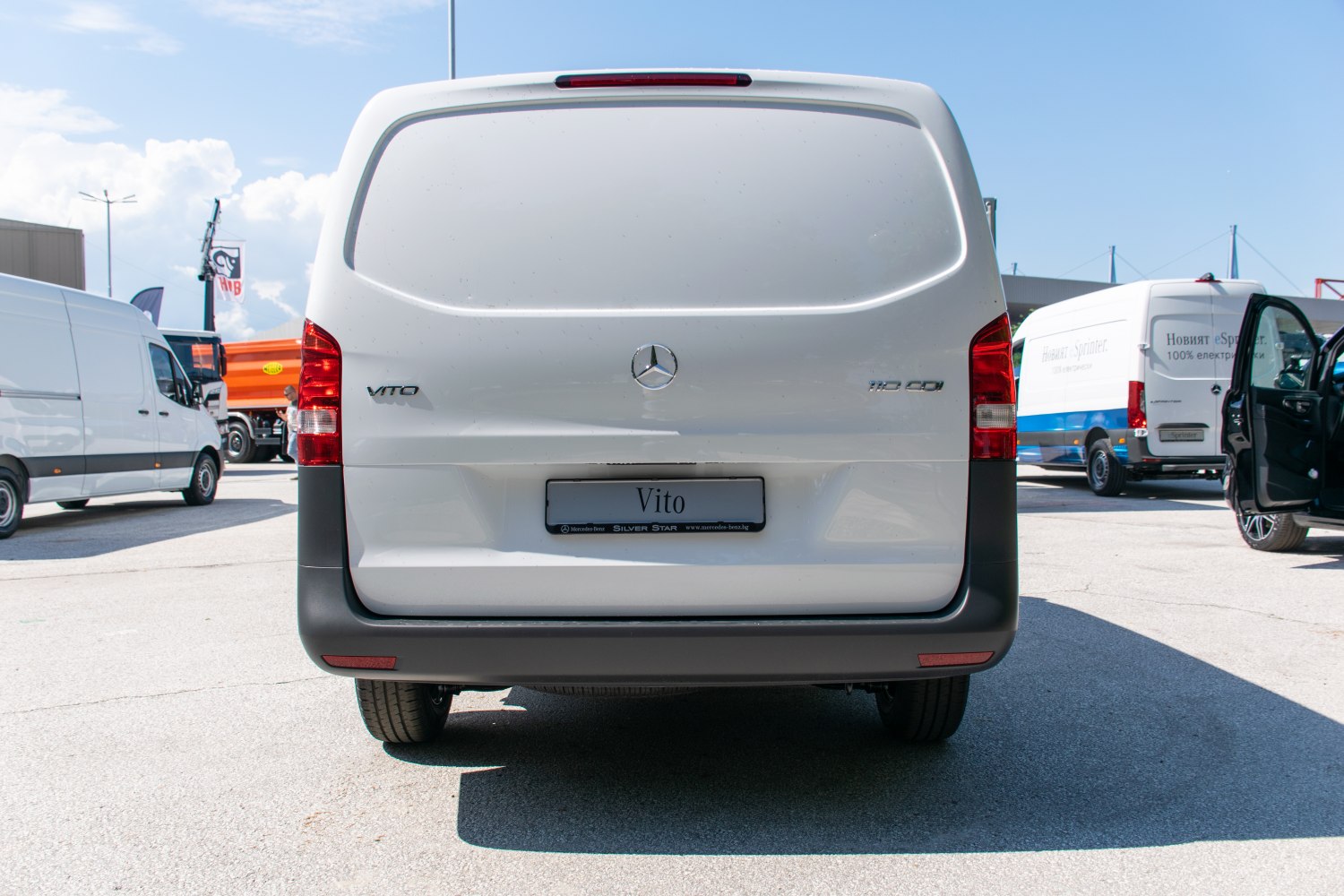 Large solid rear door with rear lights on a white van