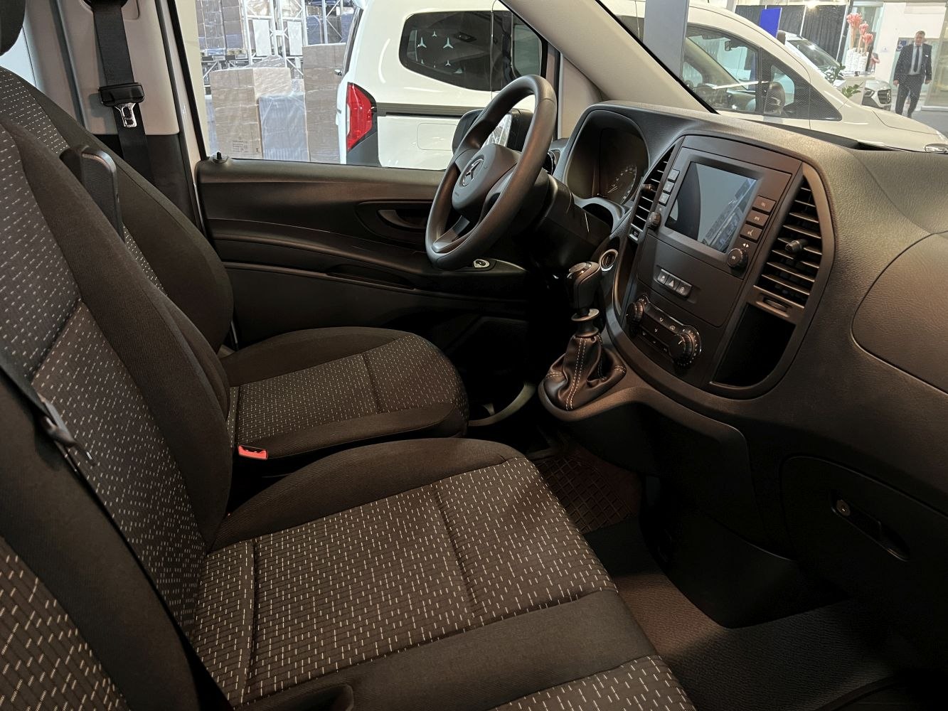 Van interior with seats, dashboard, and steering wheel