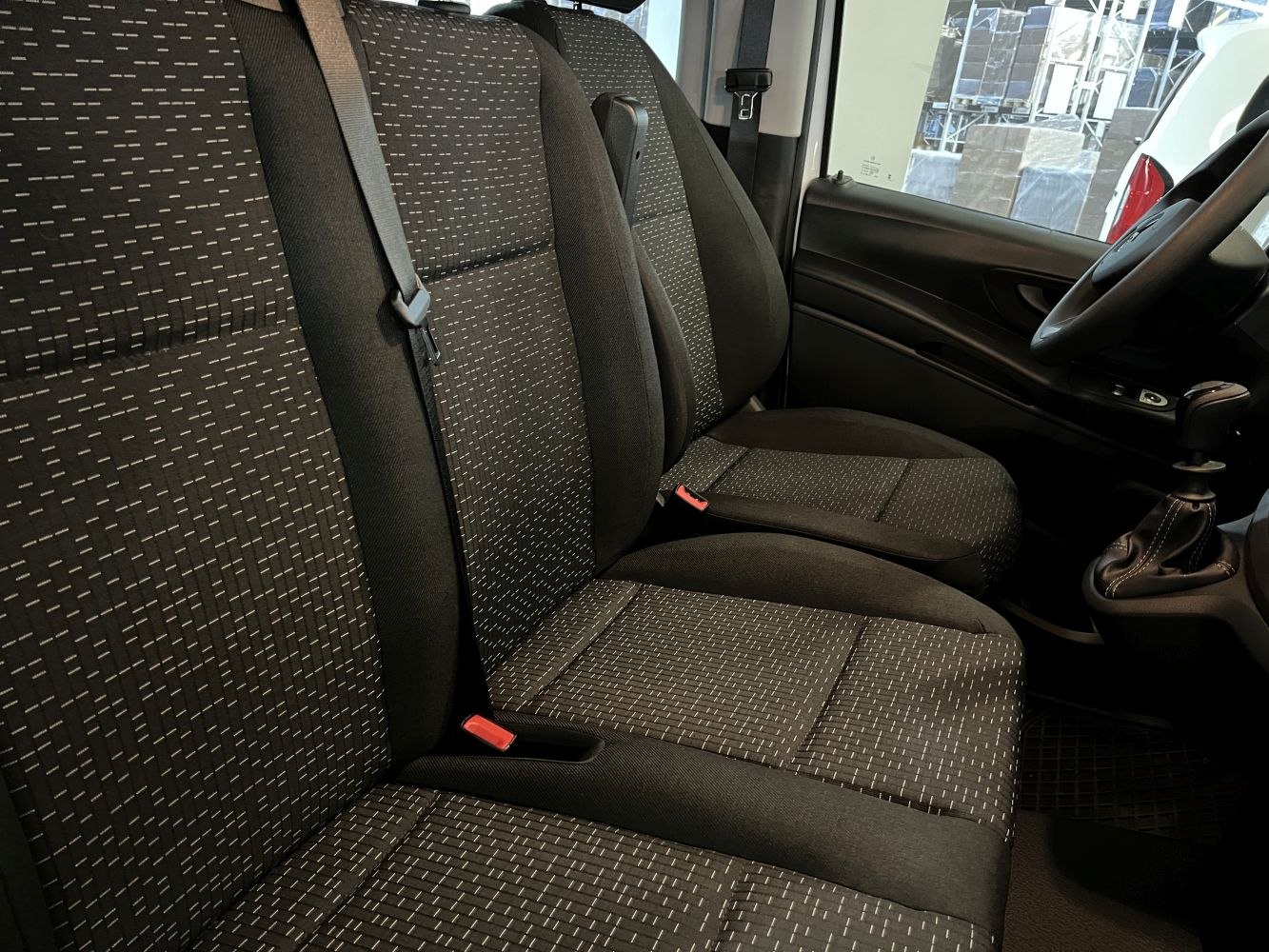 Textured fabric seats and driver area with gear shift and dashboard details