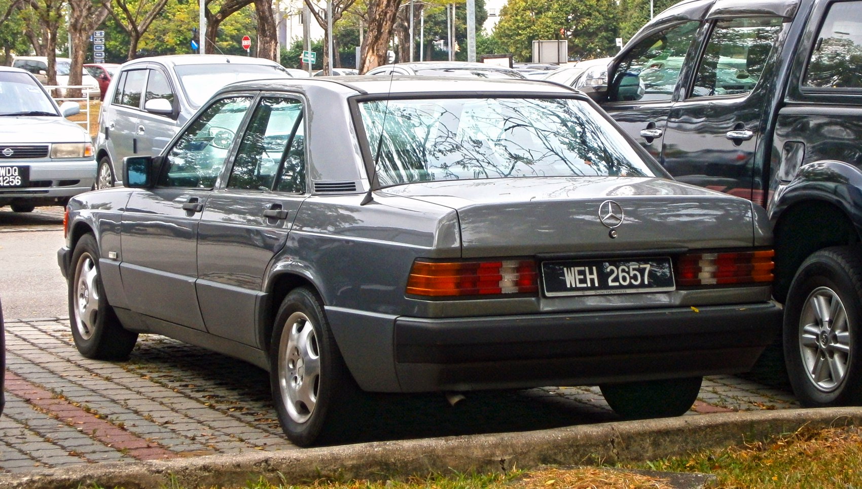 Rear view of a classic four-door sedan with distinctive tail lights and smooth roofline.