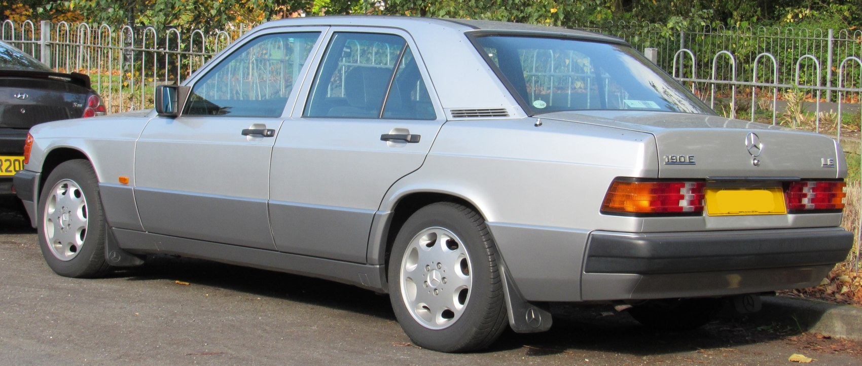 Silver sedan rear three-quarter view with alloy wheels
