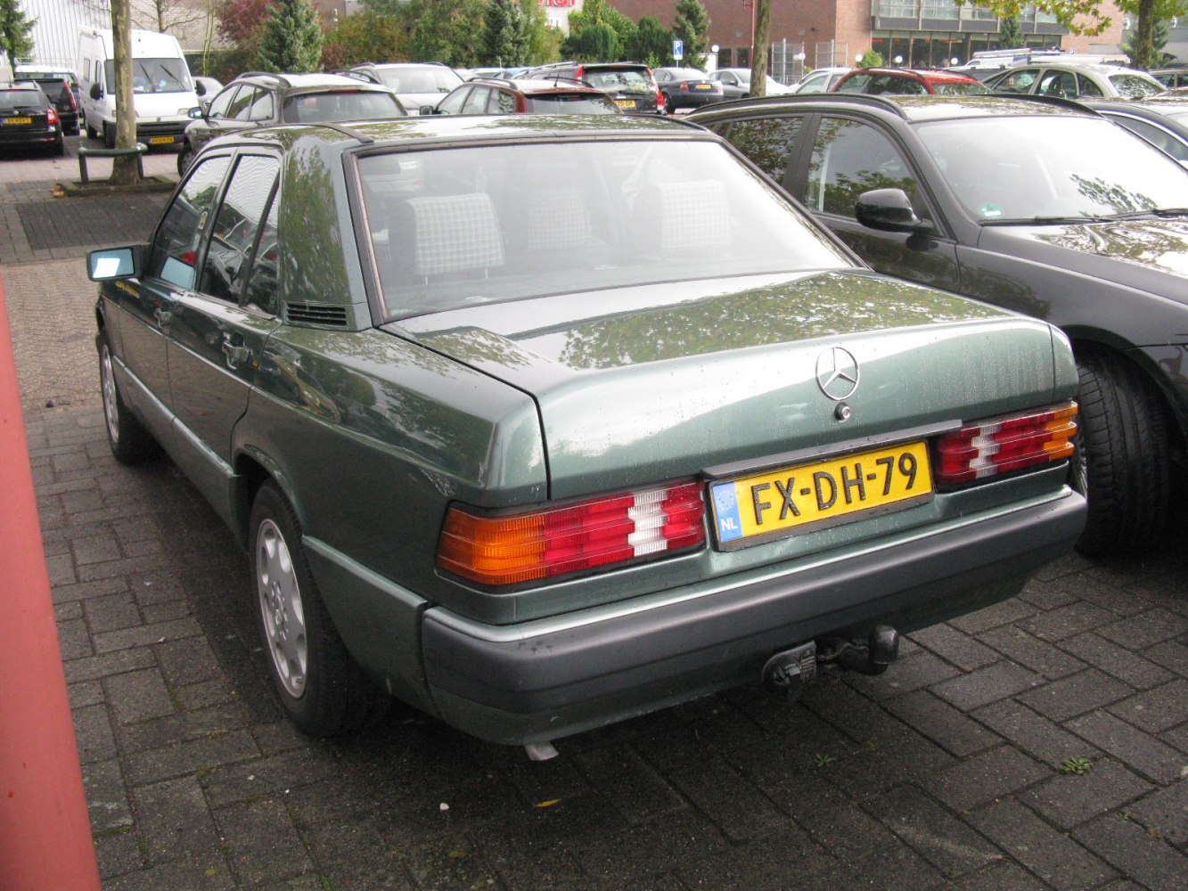 Rear view with facelift taillights and distinctive sedan rear design.