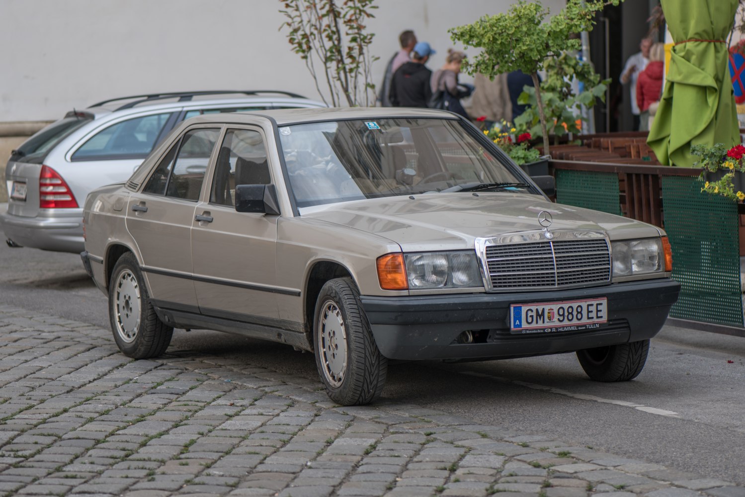 Vintage sedan with square headlights and chrome grille in front view.