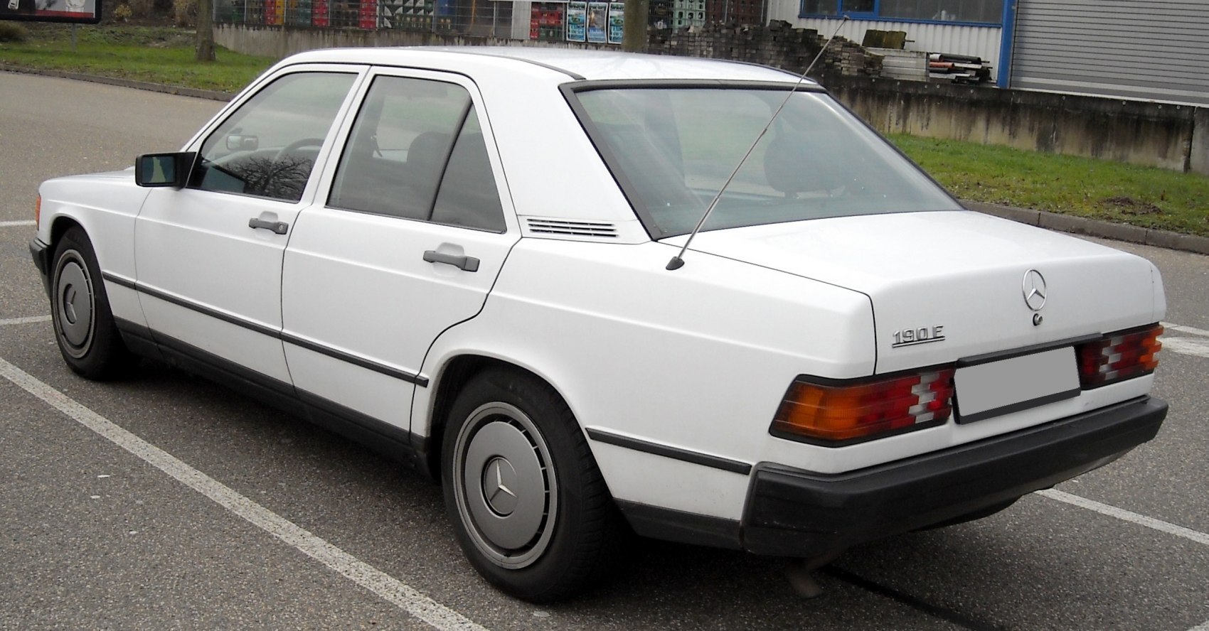Rear side view of classic Mercedes sedan with hubcaps and antenna