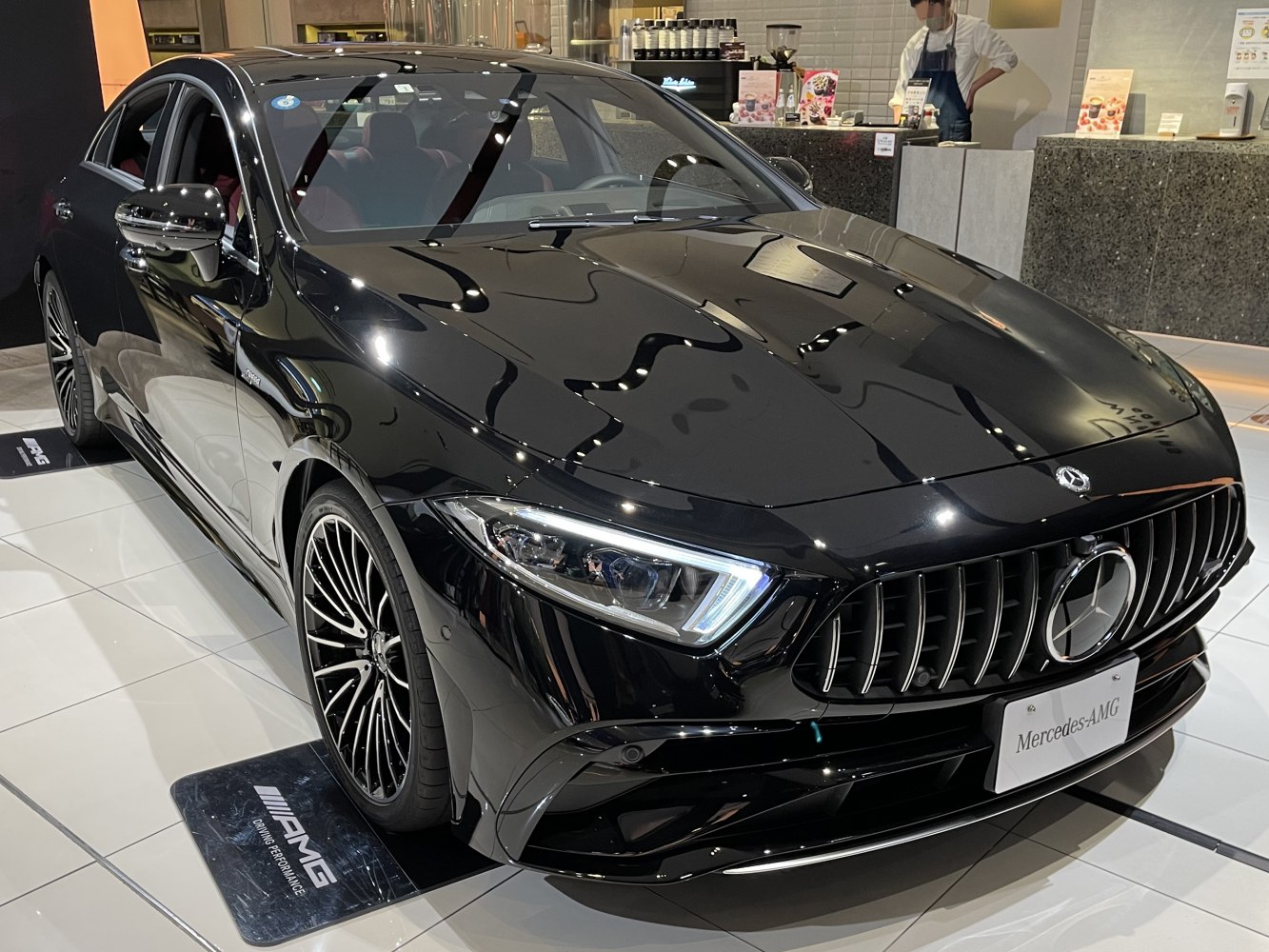 Aggressive AMG front grille and sleek LED headlights on black luxury coupe