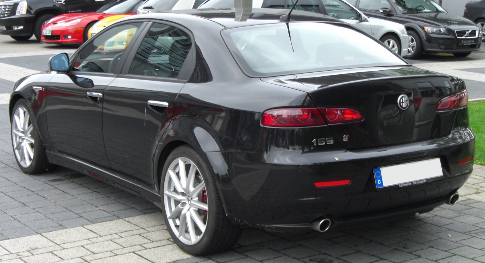 Rear and side view of sedan with brake lights and alloy wheels