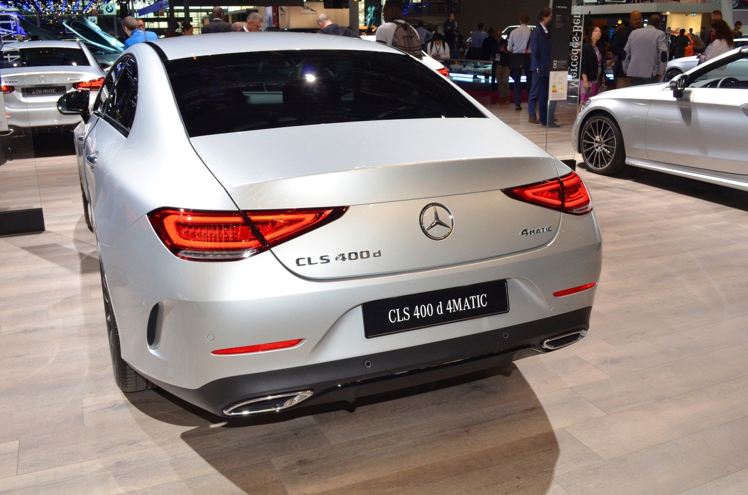 Rear view of luxury coupe with taillights and dual exhausts.
