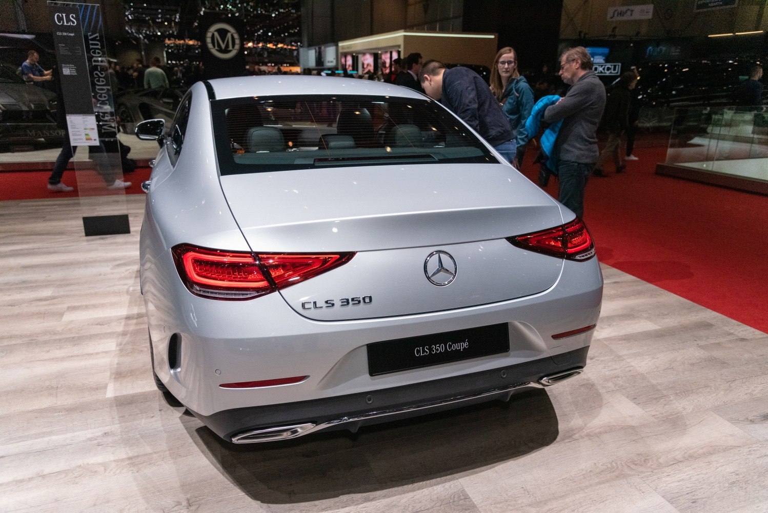 Rear view of luxury coupe with distinctive taillights and exhaust design.