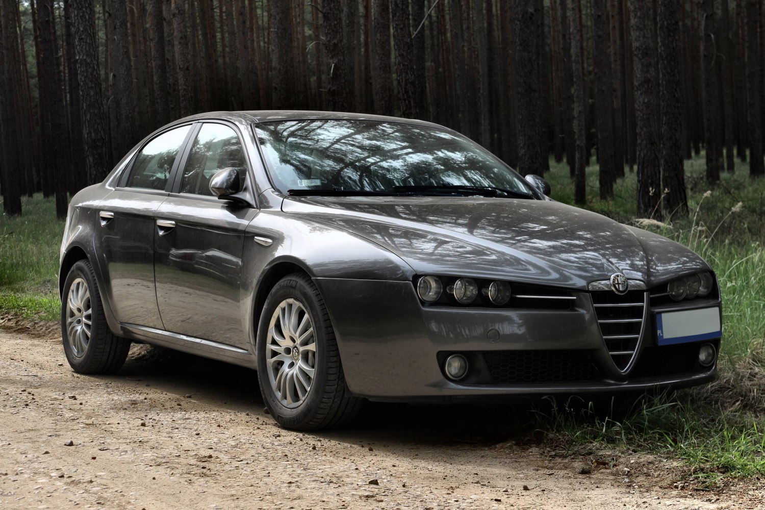 Distinctive front grille and triple round headlights on a sedan.