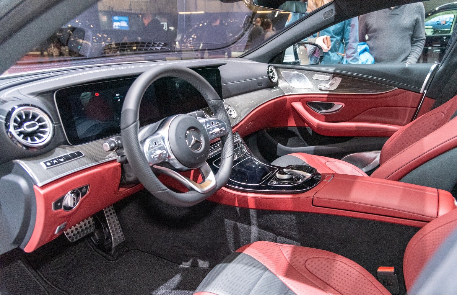 Luxury red and black interior with advanced steering wheel and digital display