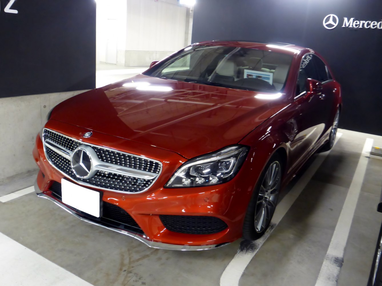 Front view with diamond grille and LED headlights in red coupe.