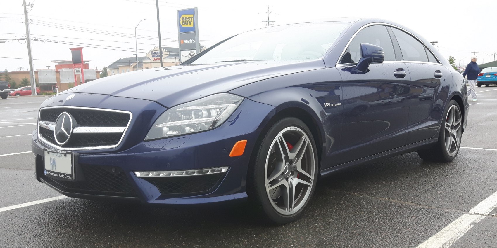 Front and side view of blue luxury coupe with V8 Biturbo badge and AMG wheels