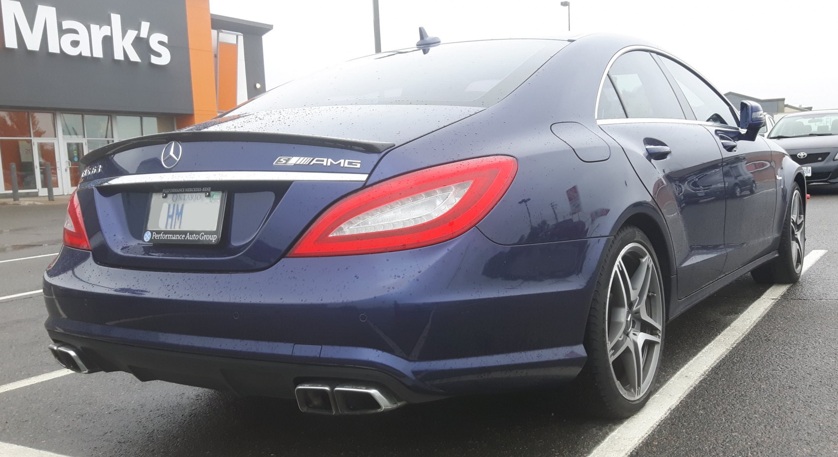 Rear view with AMG badge, taillights, quad exhaust, sleek coupe design