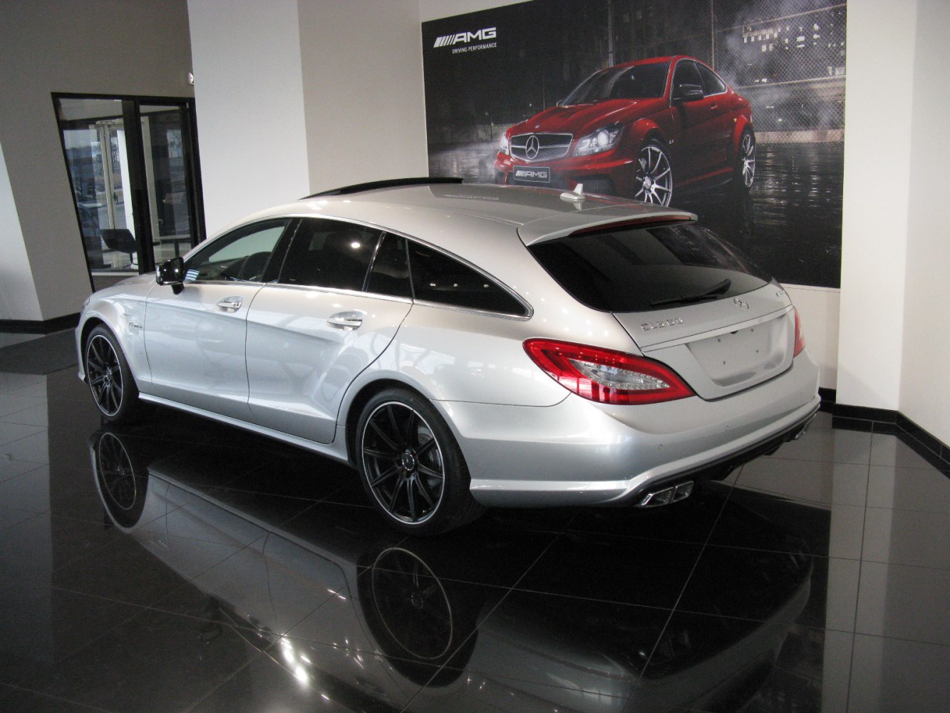 Silver luxury shooting brake with AMG styling and black sports wheels.