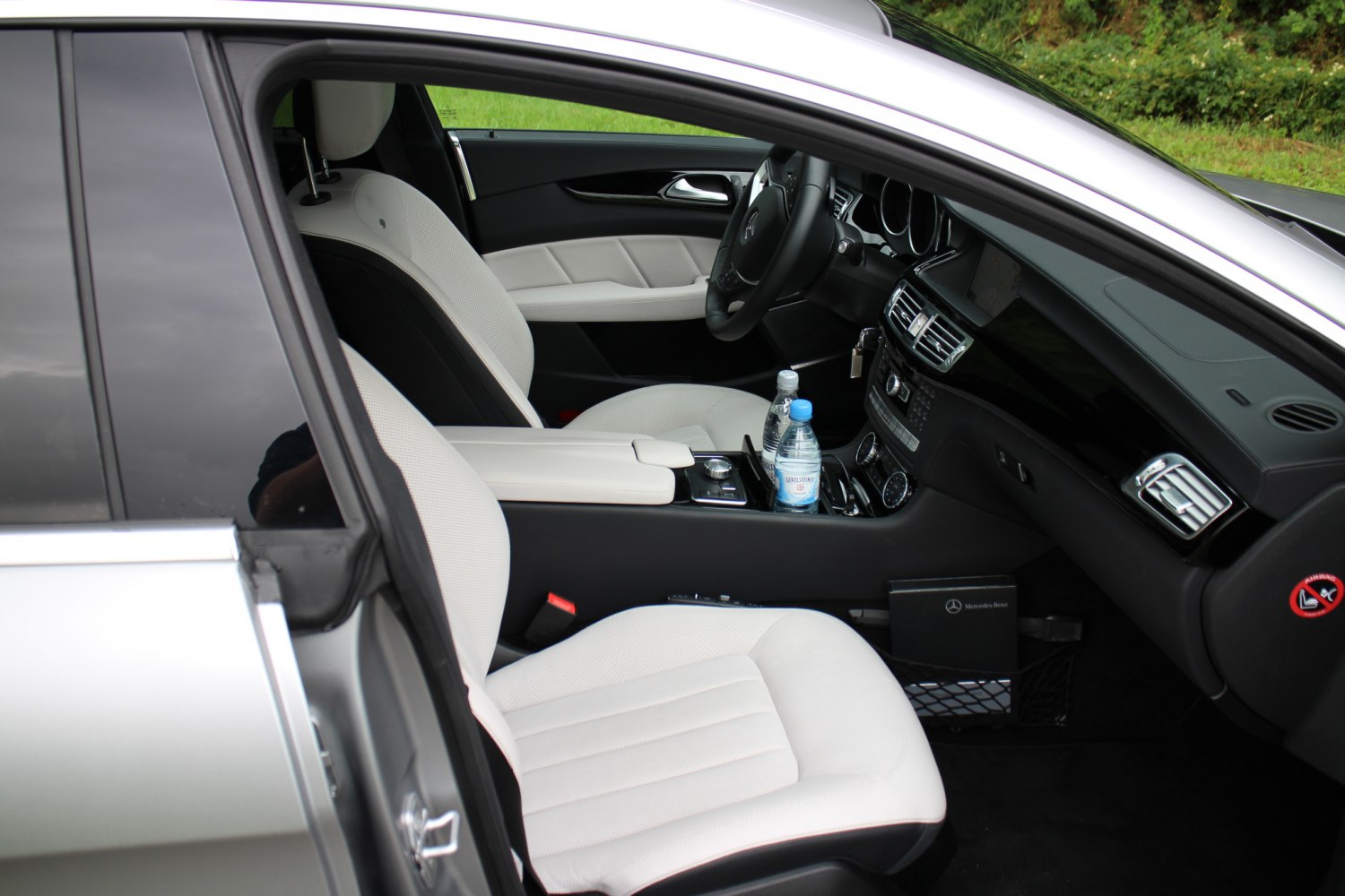 Luxurious white leather seats and advanced dashboard controls in a modern car interior