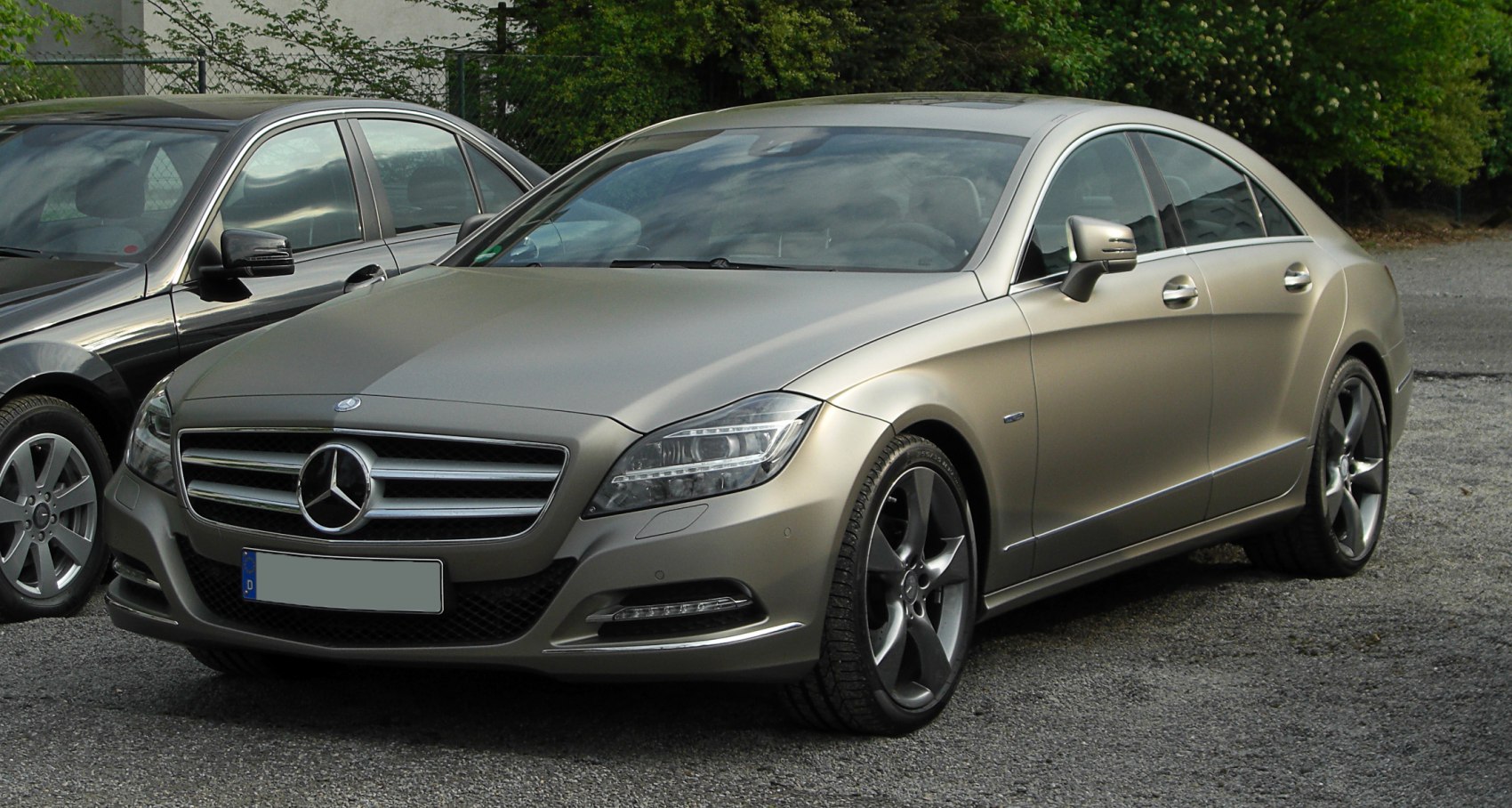 Luxury coupe with matte finish, modern headlights, and five-spoke alloy wheels