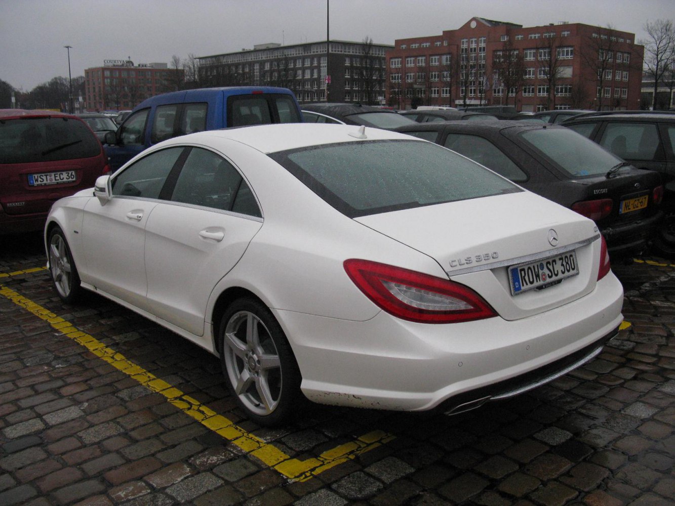 White luxury coupe rear view with distinctive taillights and smooth design