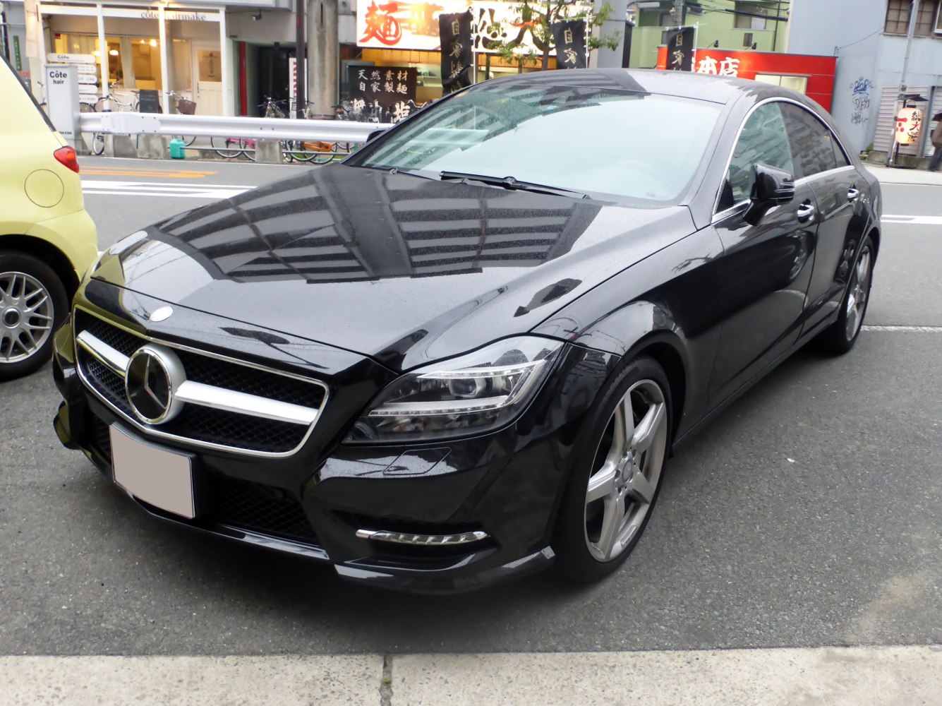Front-angle view of black luxury sedan with LED headlights and alloy wheels