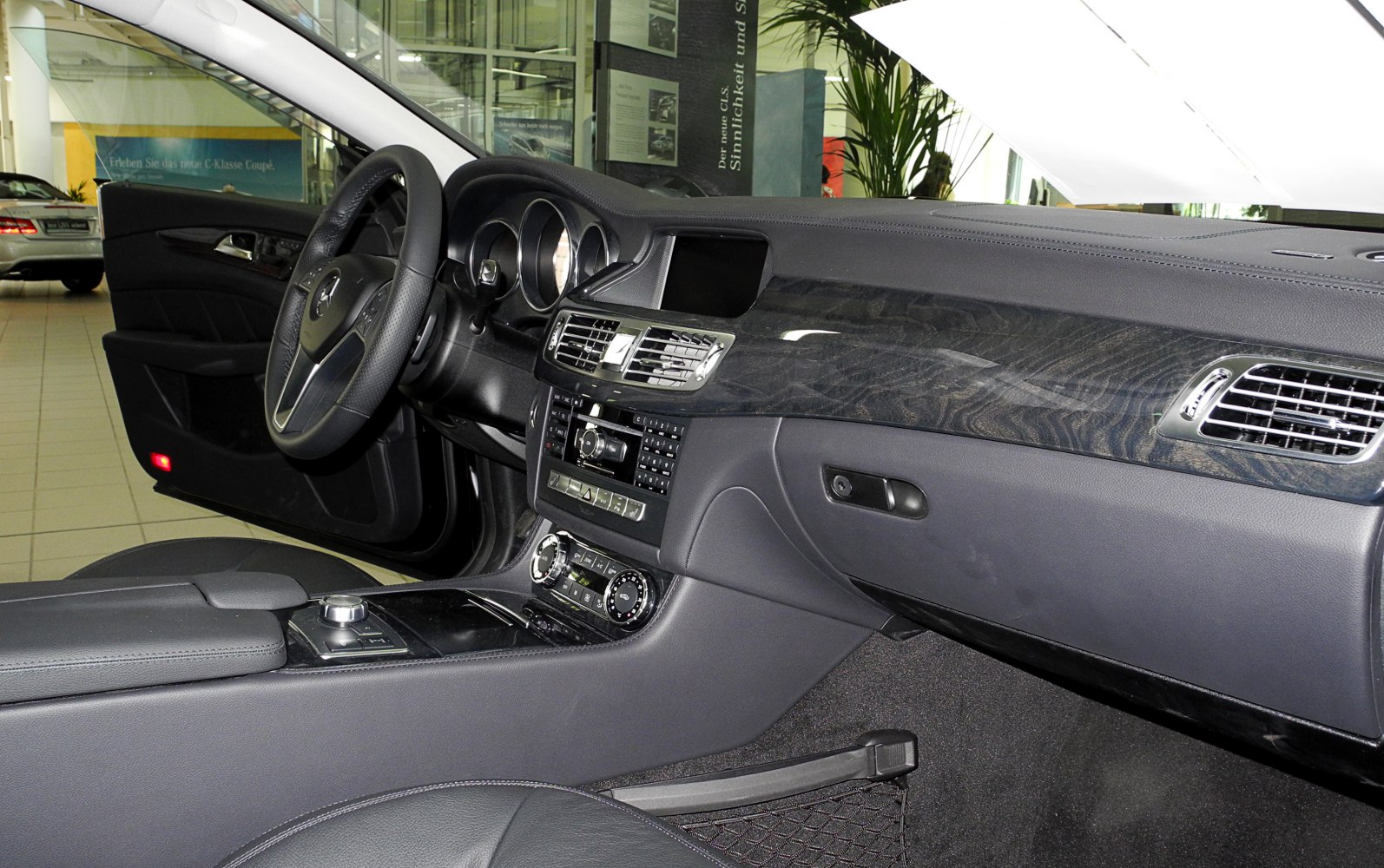 Luxury car interior with wood trim dashboard and advanced control panel