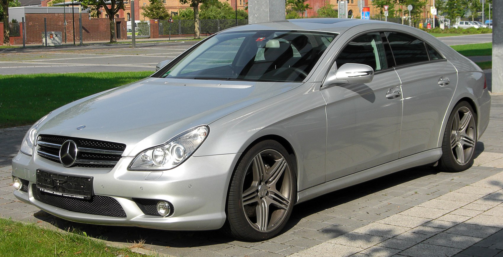 Silver luxury coupe front and side view with sleek headlights and alloy wheels