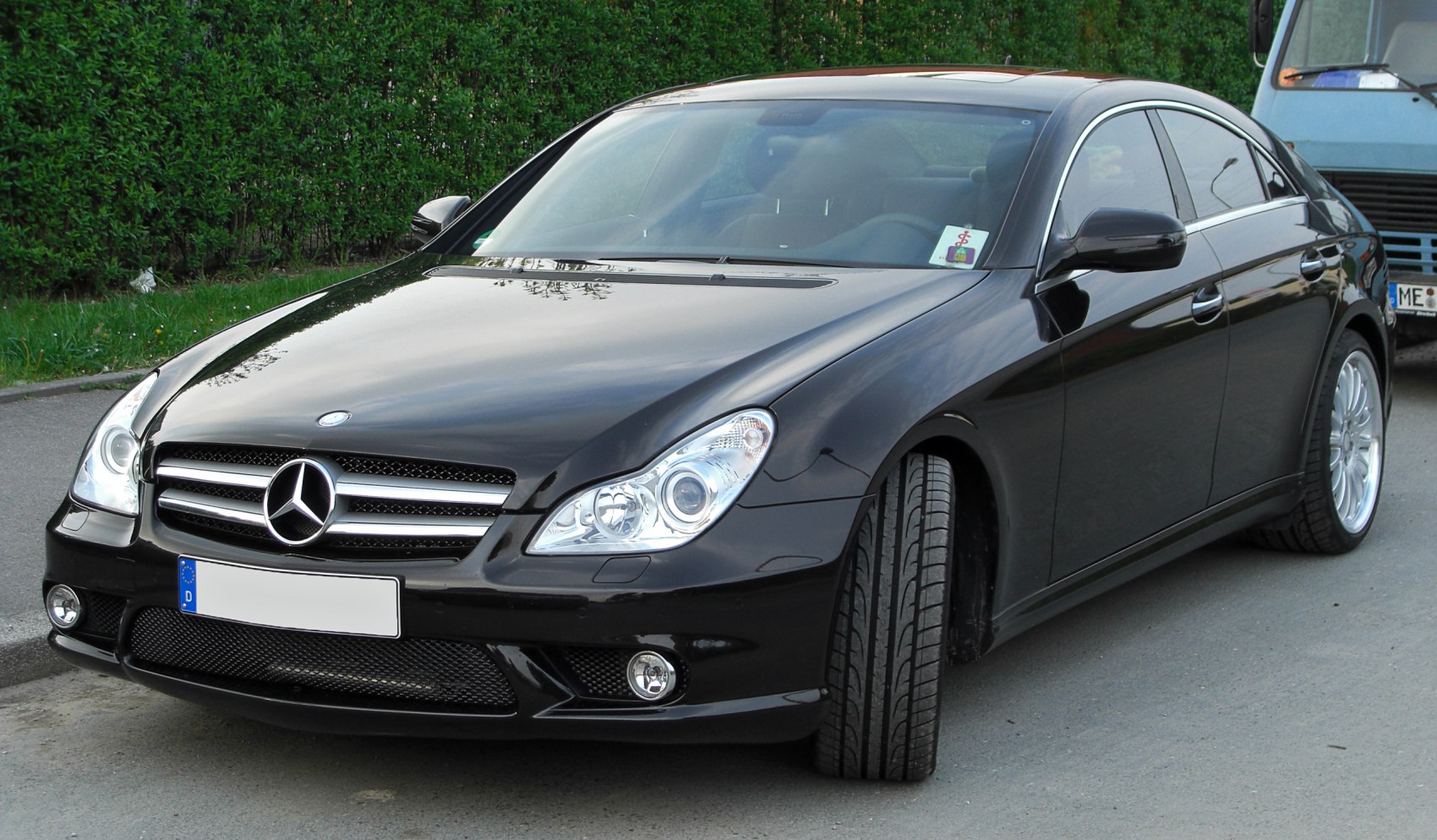 Luxury coupe front with grille, headlights, and sporty wheels