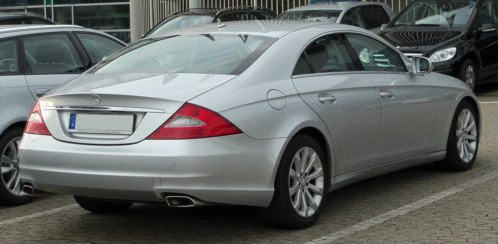 Rear view of sleek coupe with distinctive tail lights and dual exhausts