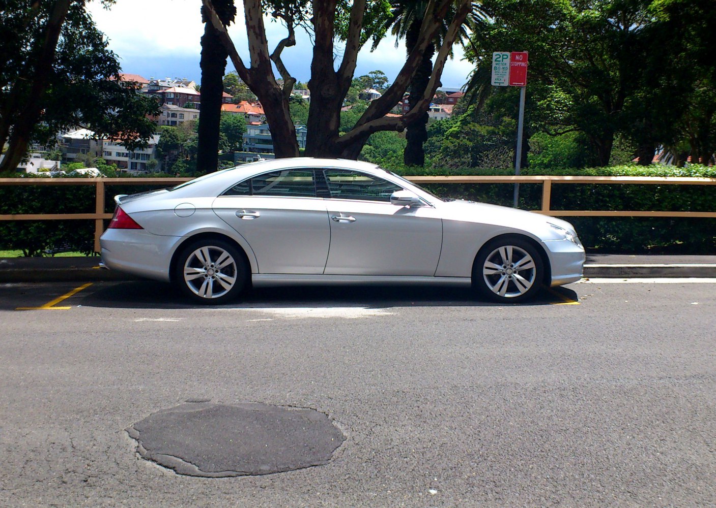 Side profile of a sleek four-door coupe with alloy wheels