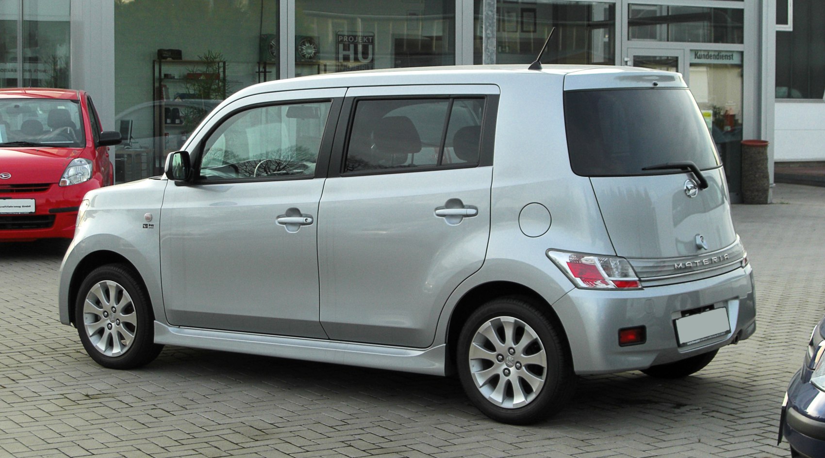 Silver compact boxy hatchback side and rear view with alloy wheels