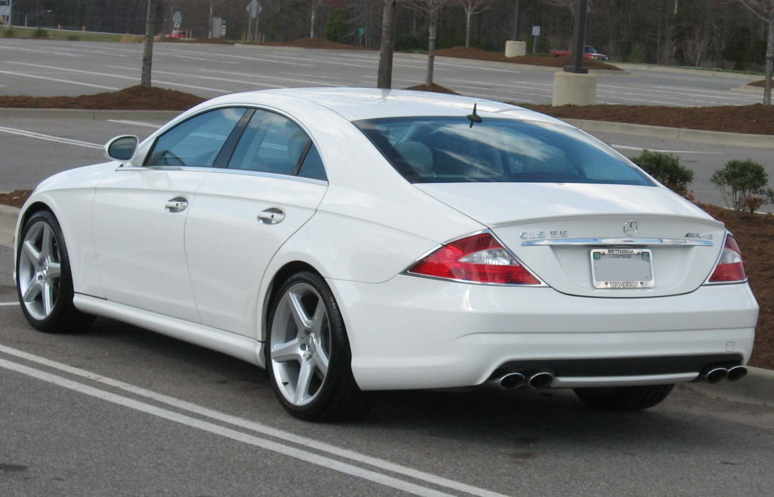 Rear view of white luxury coupe with AMG quad exhaust