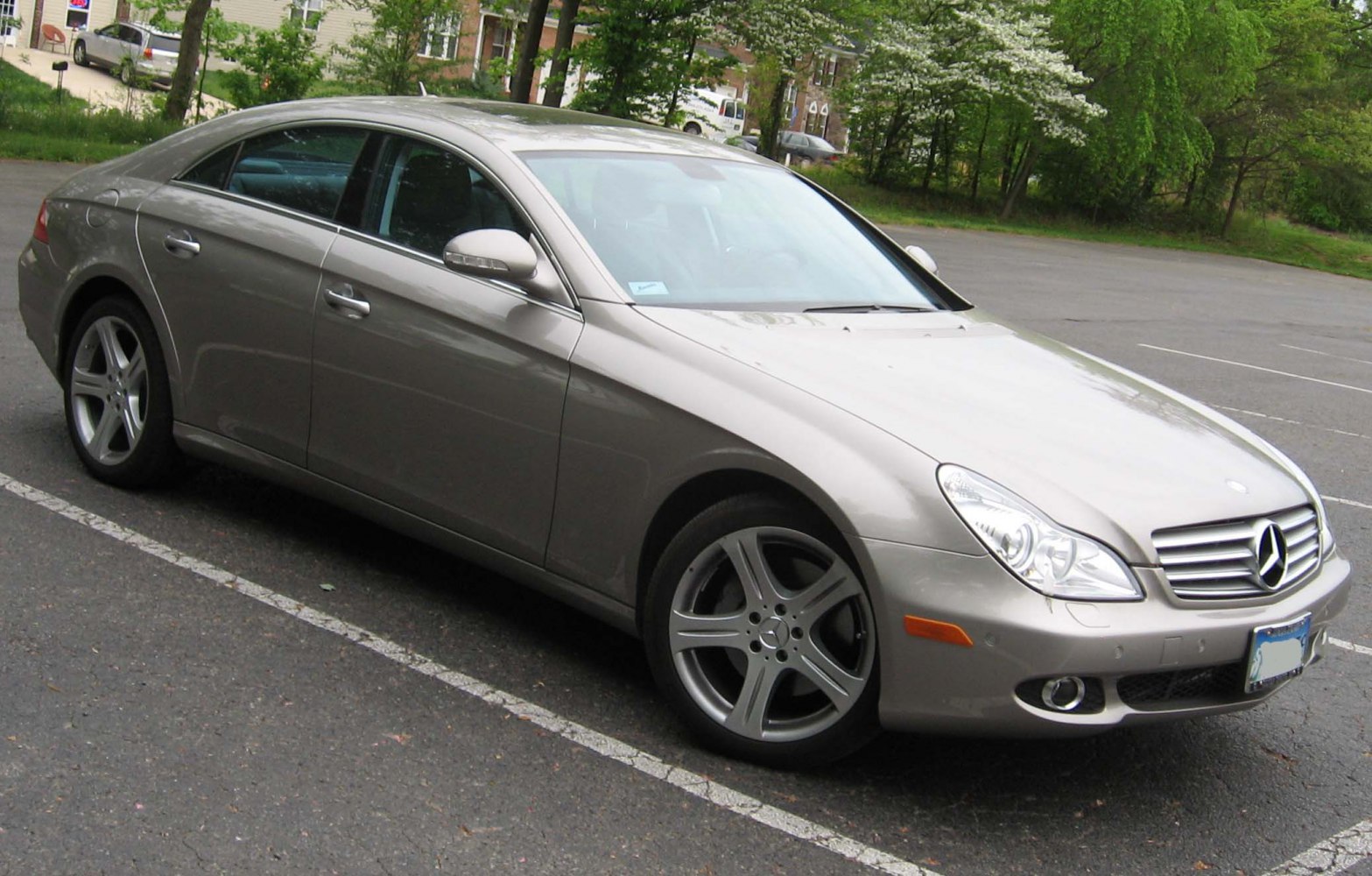 Front side view of luxury 4-door coupe with distinctive grille and alloy wheels
