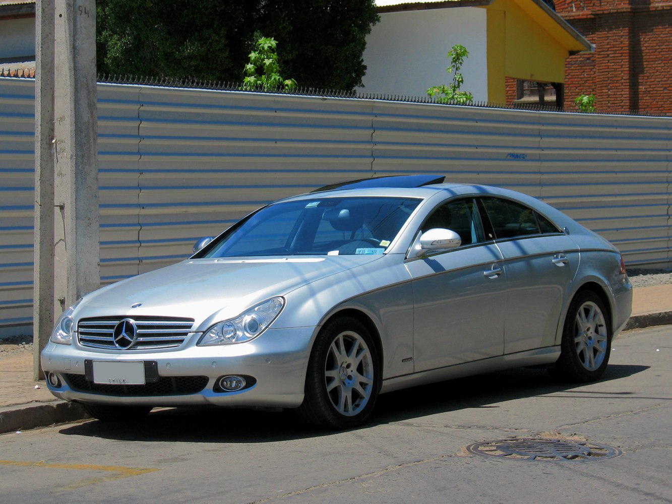 Silver luxury coupe from front side with alloy wheels and sunroof