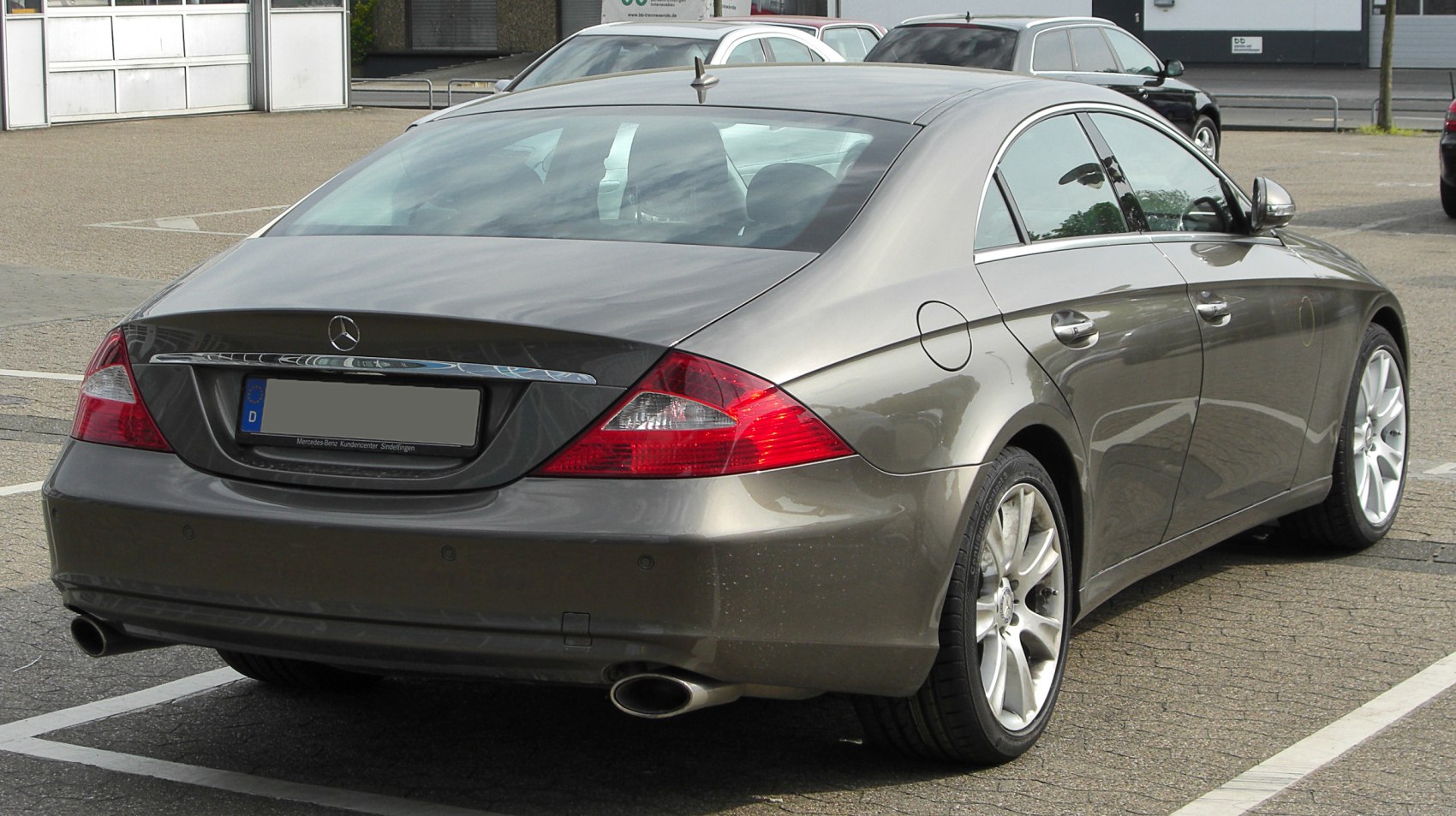 Rear view with dual exhaust and sleek taillights of a coupe vehicle