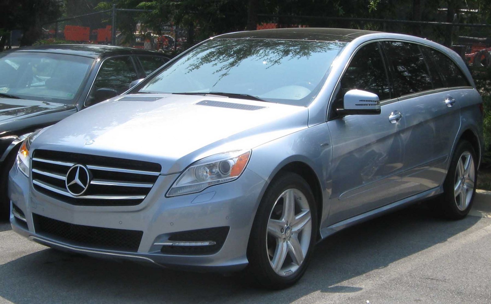 Silver luxury long-wheelbase vehicle with prominent front grille and alloy wheels