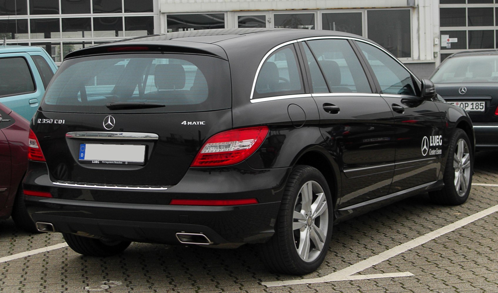 Rear view of a black elongated SUV with 4MATIC and R350 CDI badges