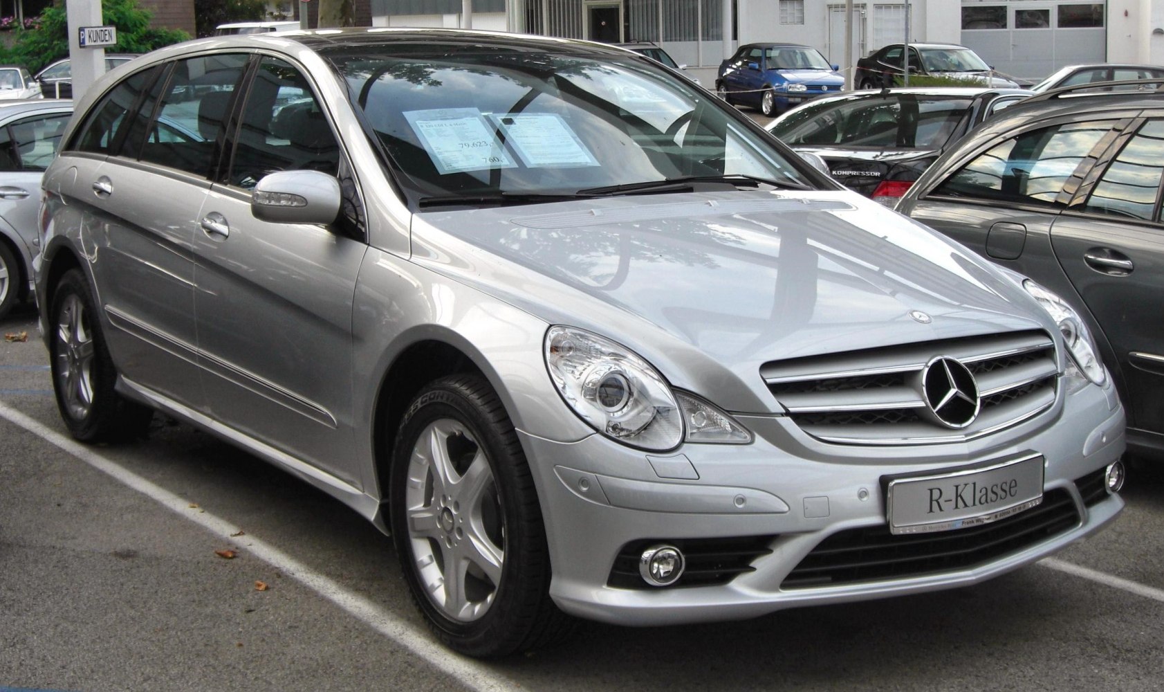 Silver luxury estate front three-quarter view with distinct grille and headlamp