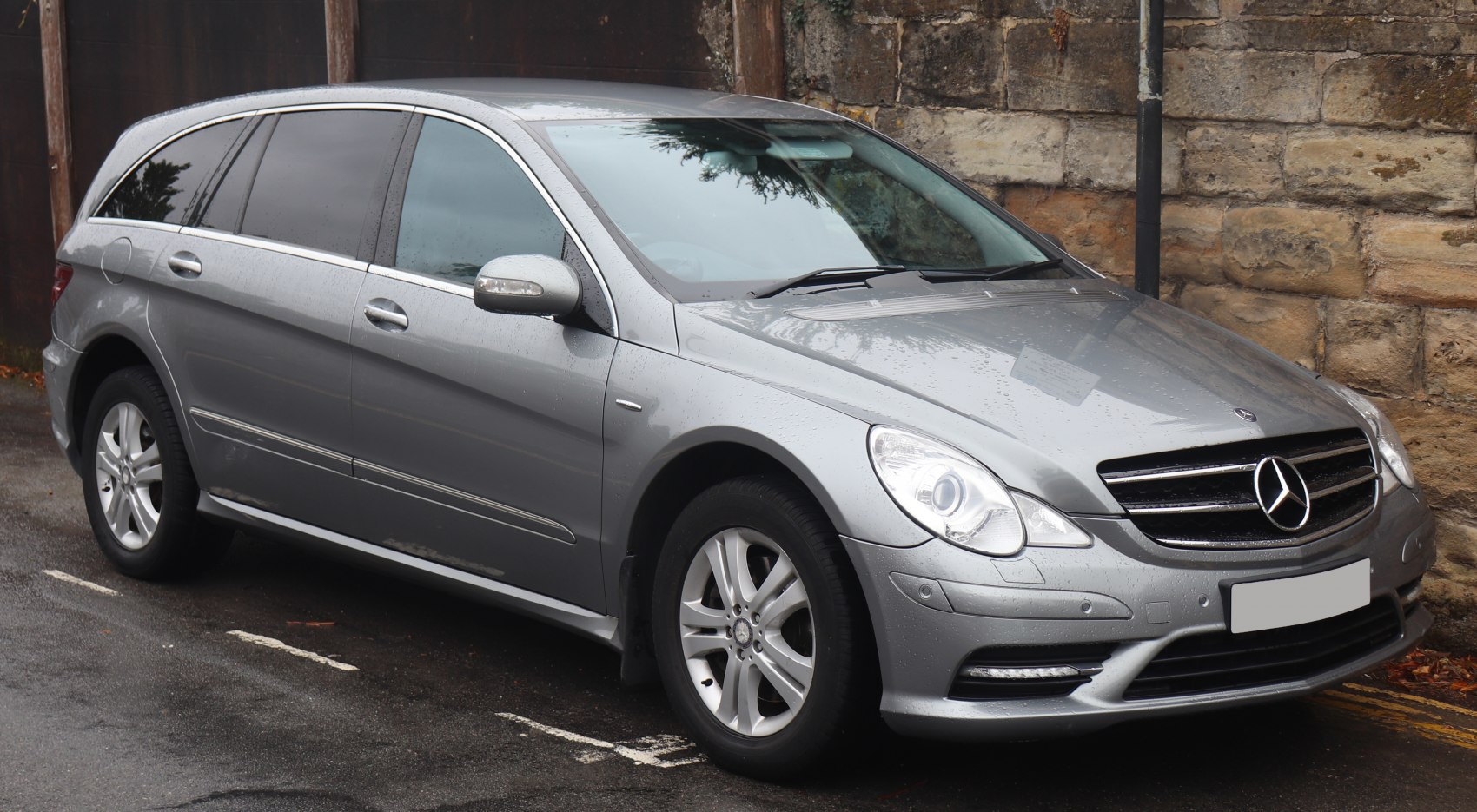 Front and side view of a long luxury vehicle with alloy wheels