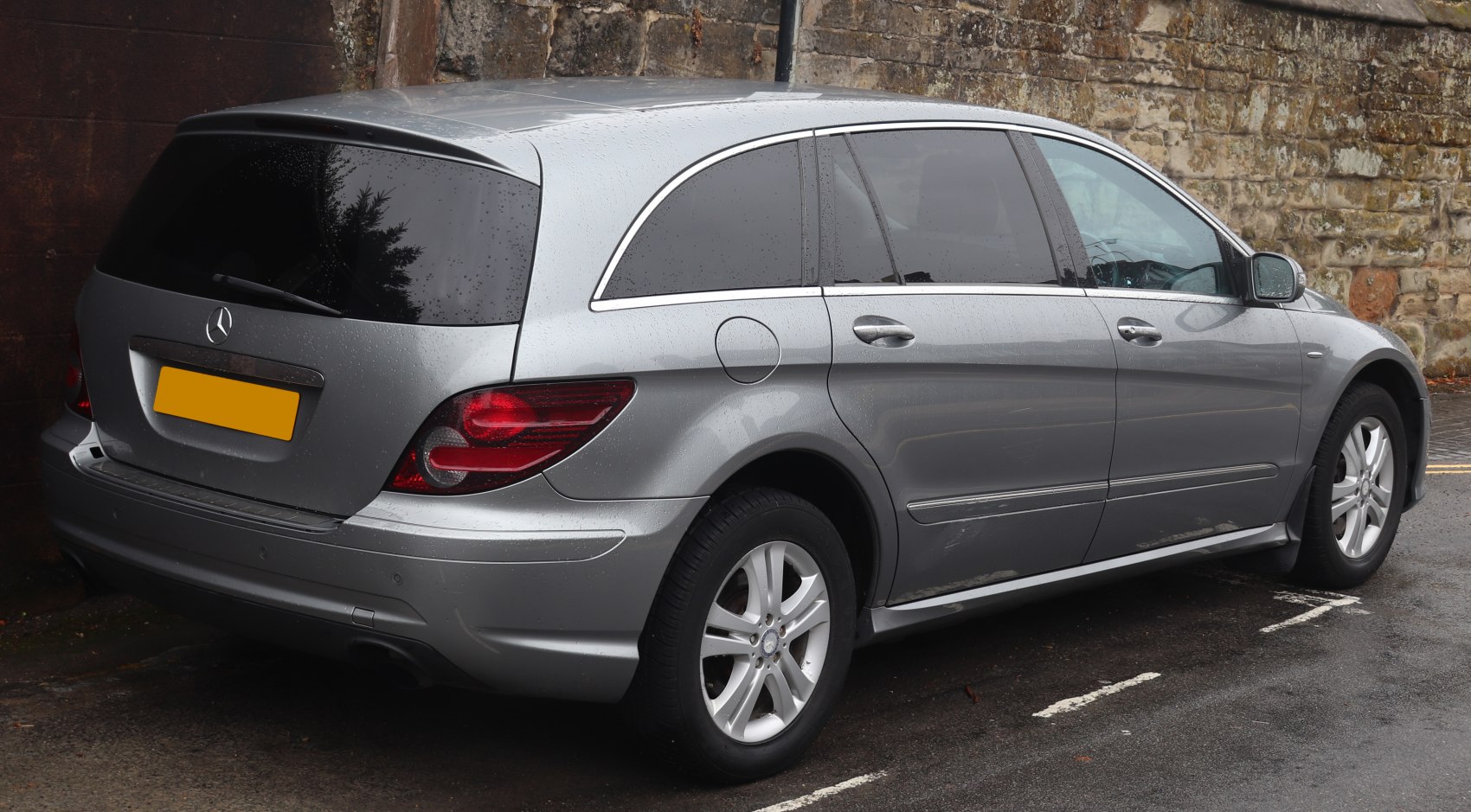 Rear and side view of silver MPV with tinted windows and alloy wheels