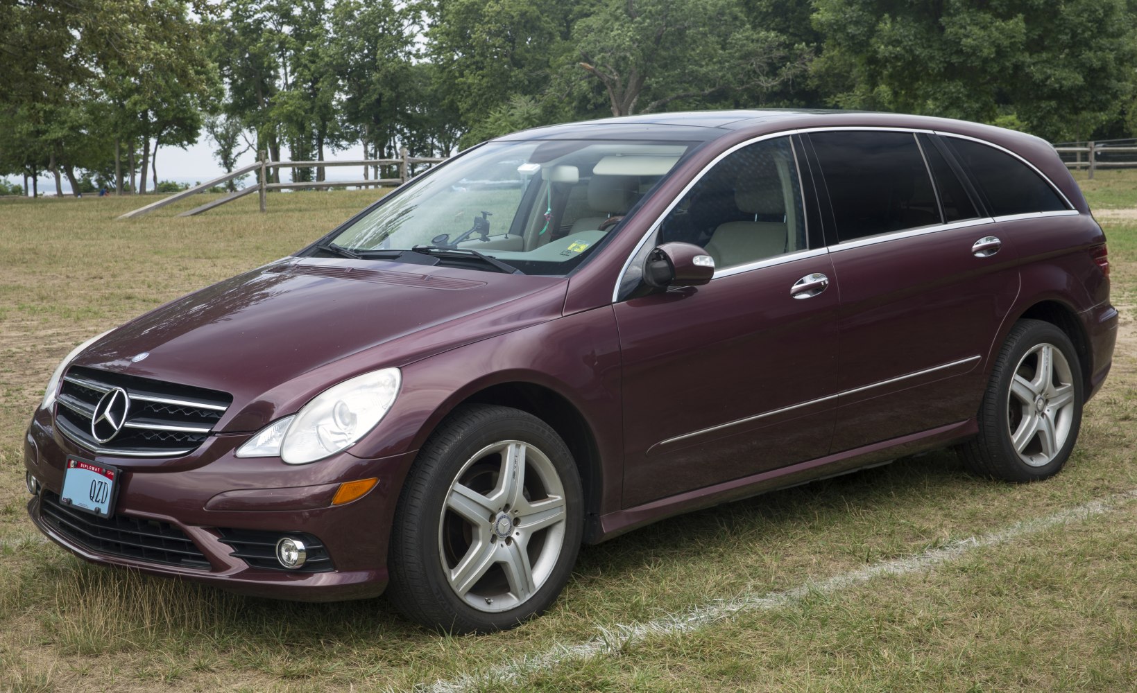 Front-side view of maroon large wagon with chrome trim and alloy wheels