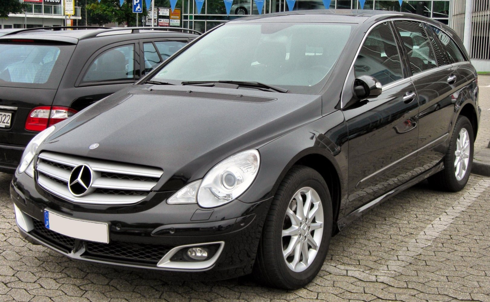 Black luxury station wagon front and side view with prominent grille and headlights