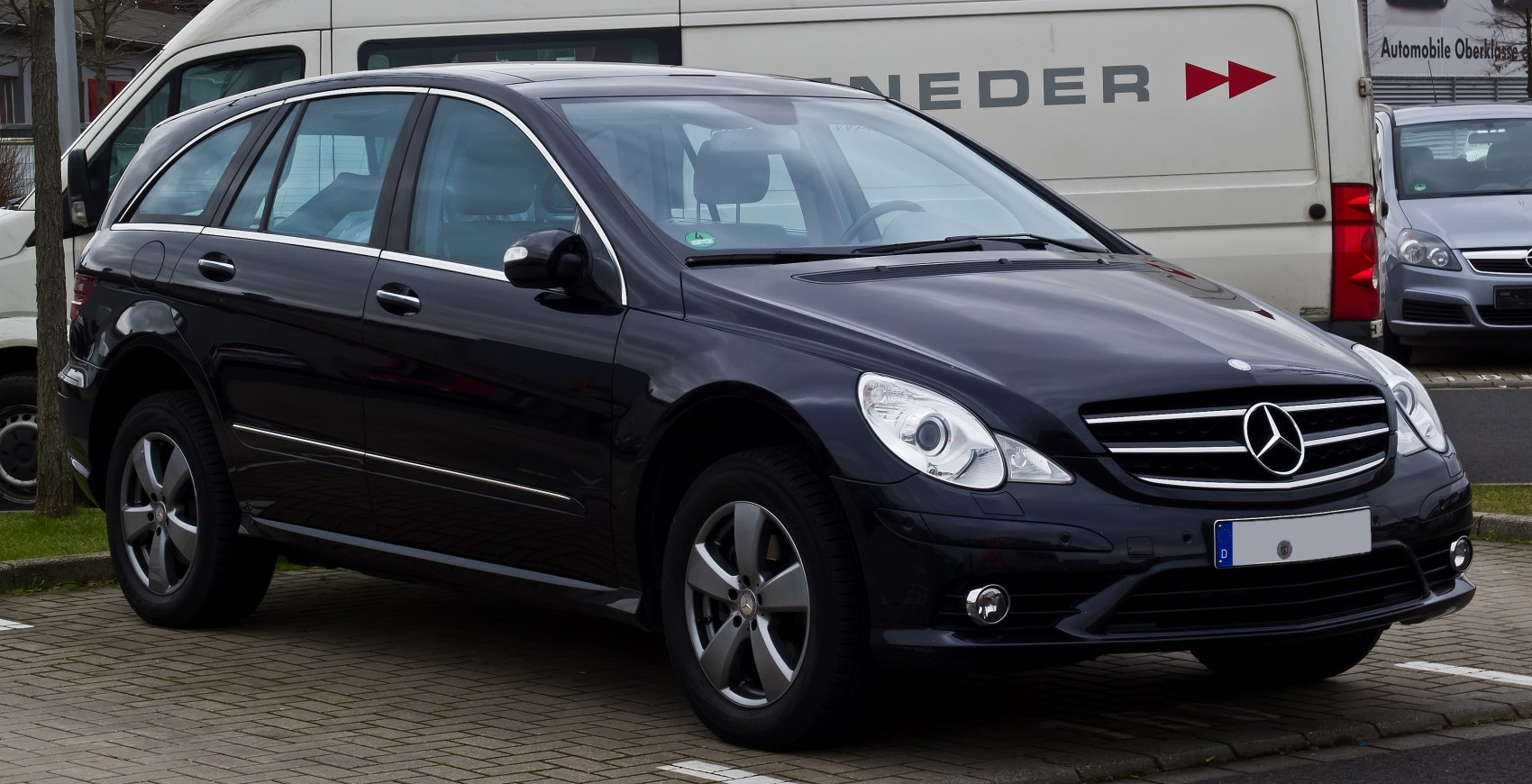Black luxury MPV front side with chrome trim and distinctive headlights