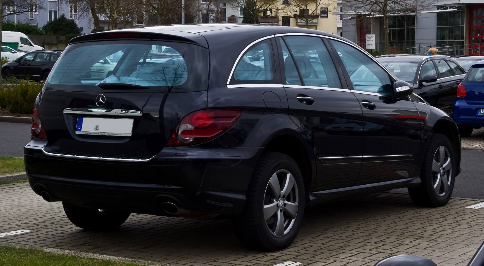 Rear view of black hatchback with distinctive taillights and chrome trim