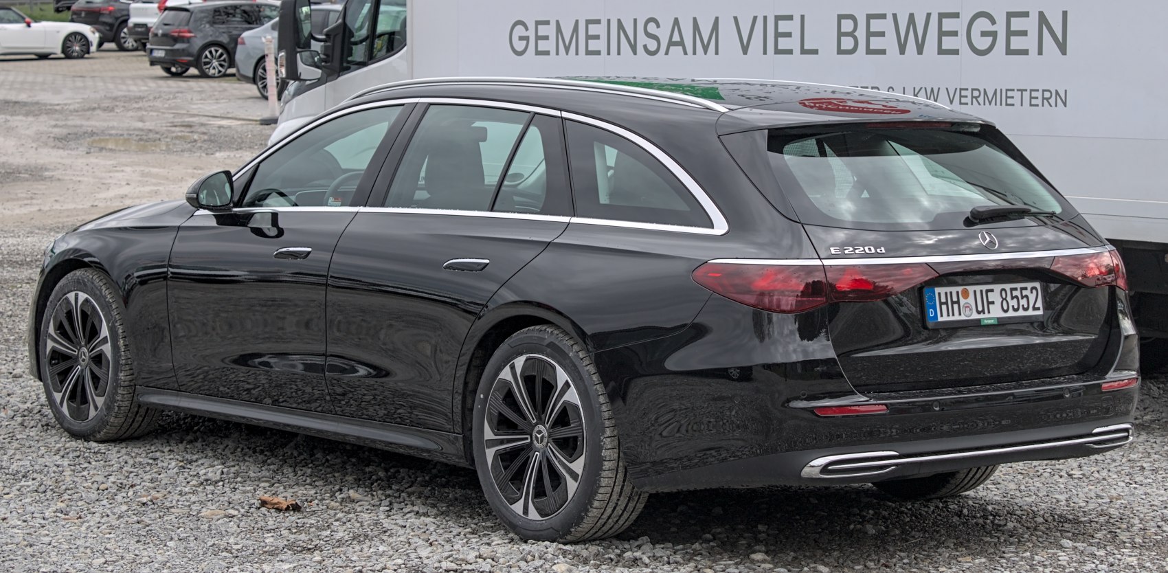 Rear side view of a sleek modern wagon with alloy wheels and aerodynamic design