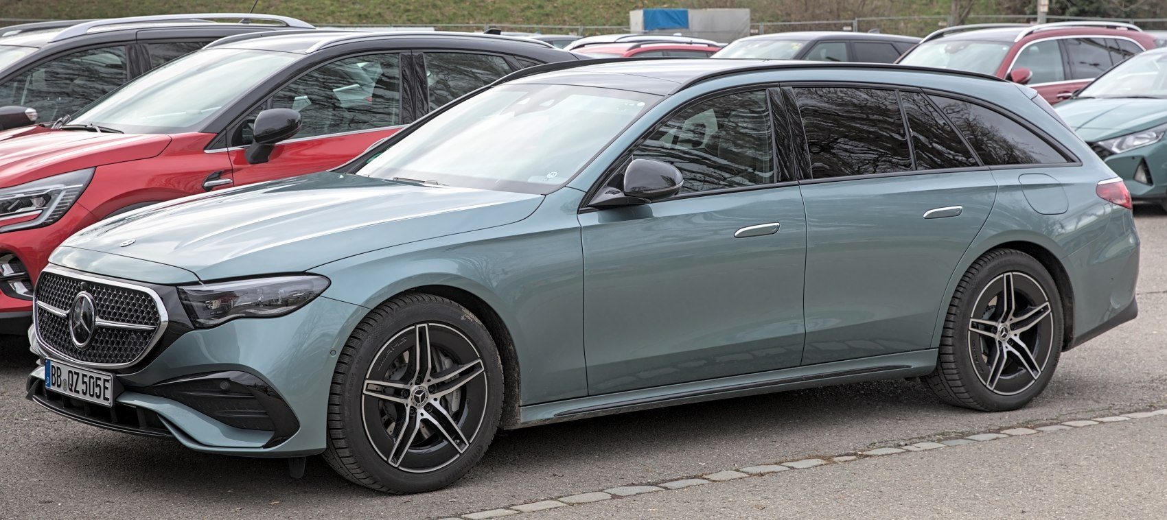 Front side view of a modern station wagon with AMG five-spoke wheels.