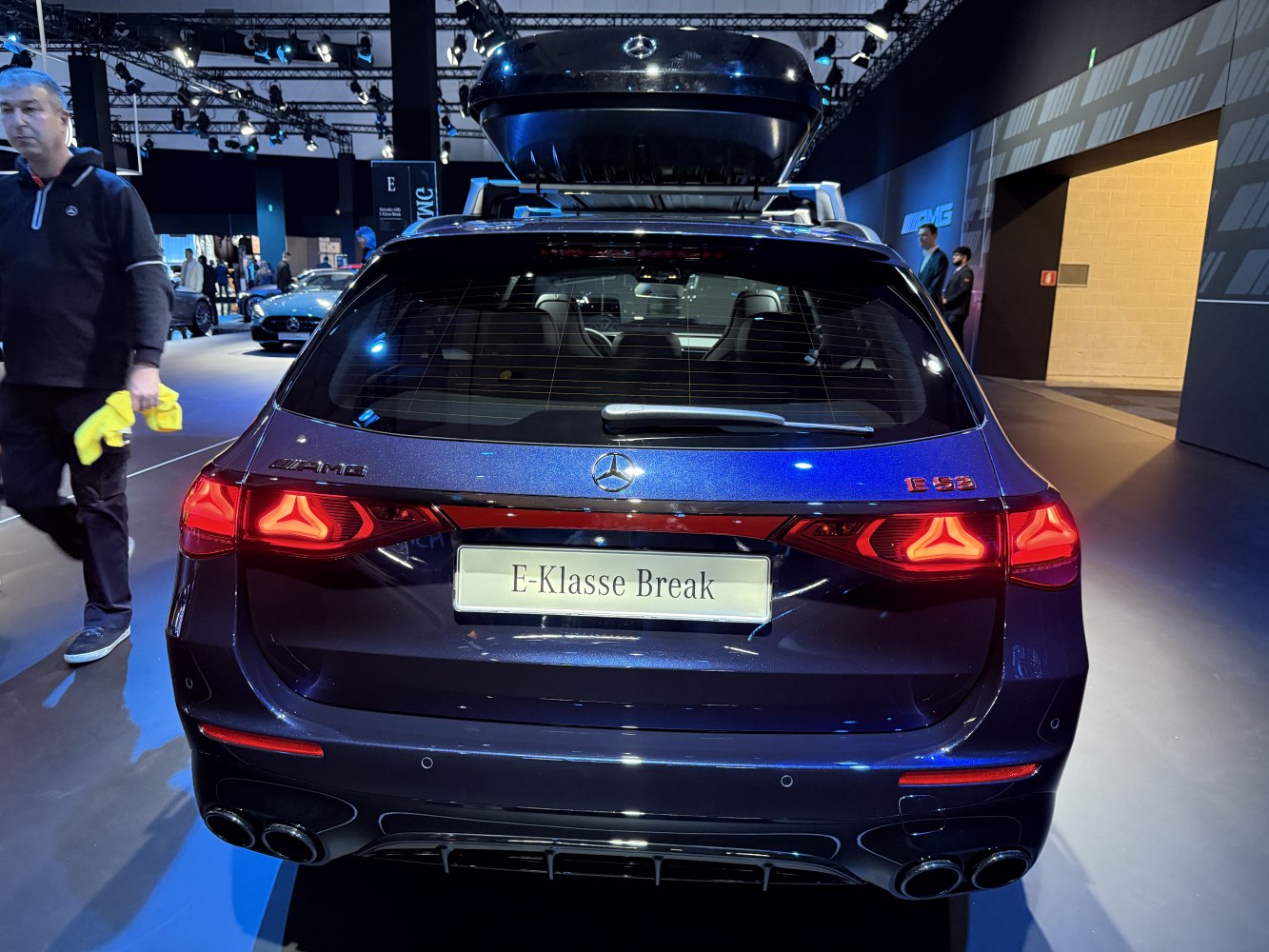 Car rear with AMG E 53 taillights and quad exhausts