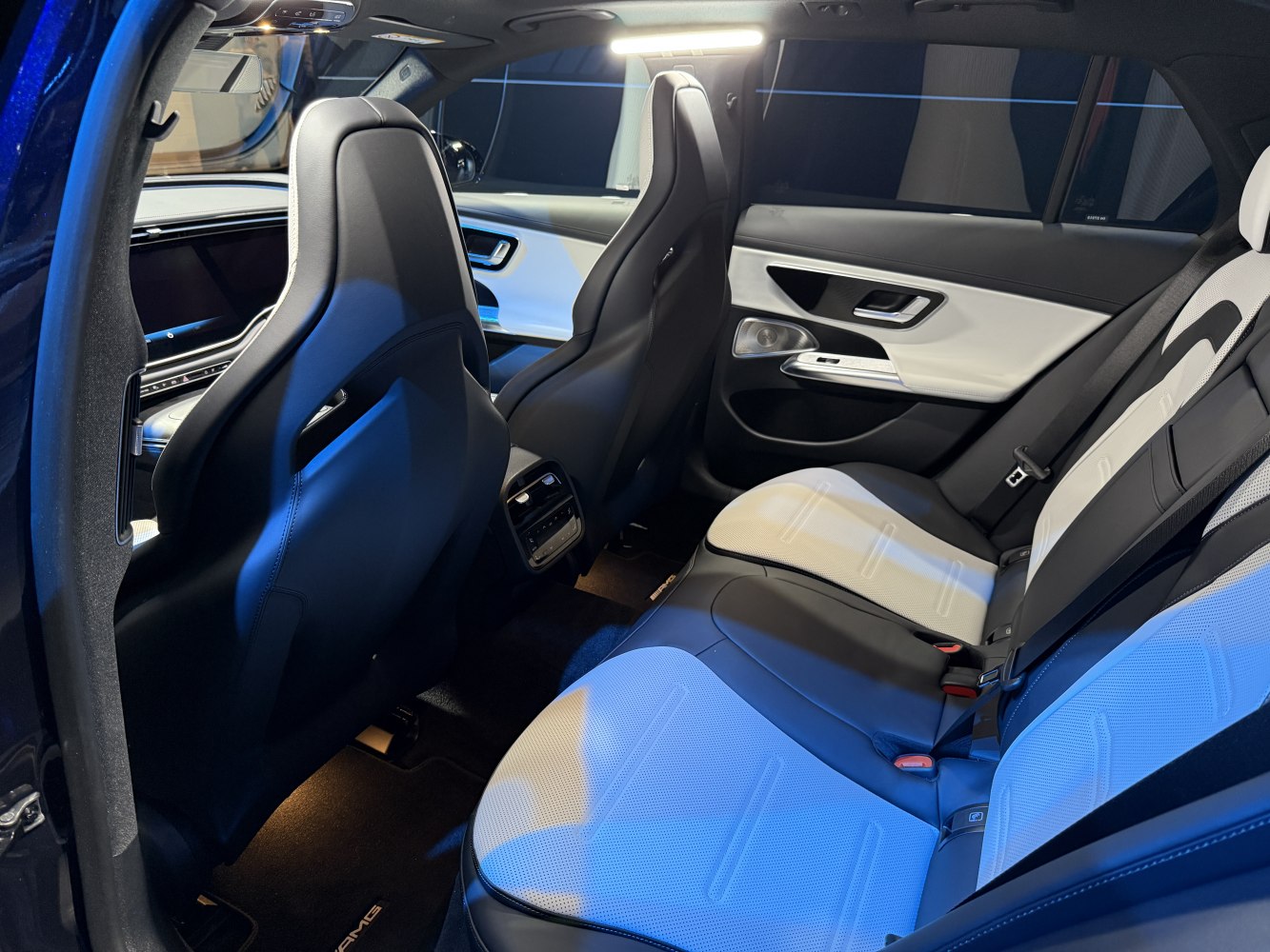 Luxury rear interior with two-tone seats and sporty front seatbacks