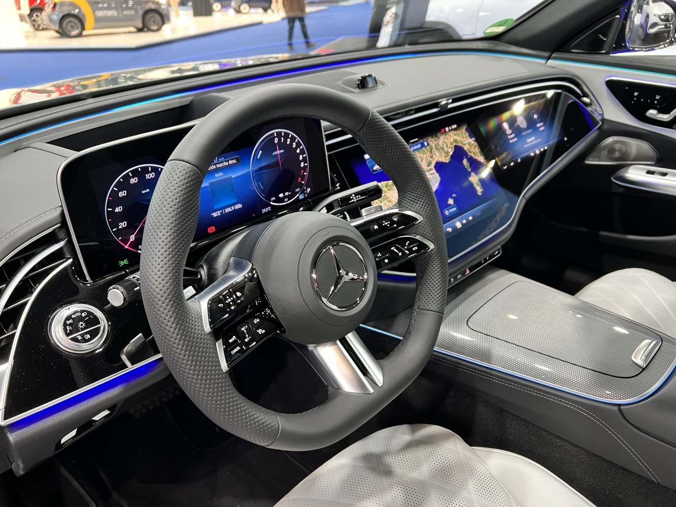 Digital cockpit and infotainment system with steering wheel controls.
