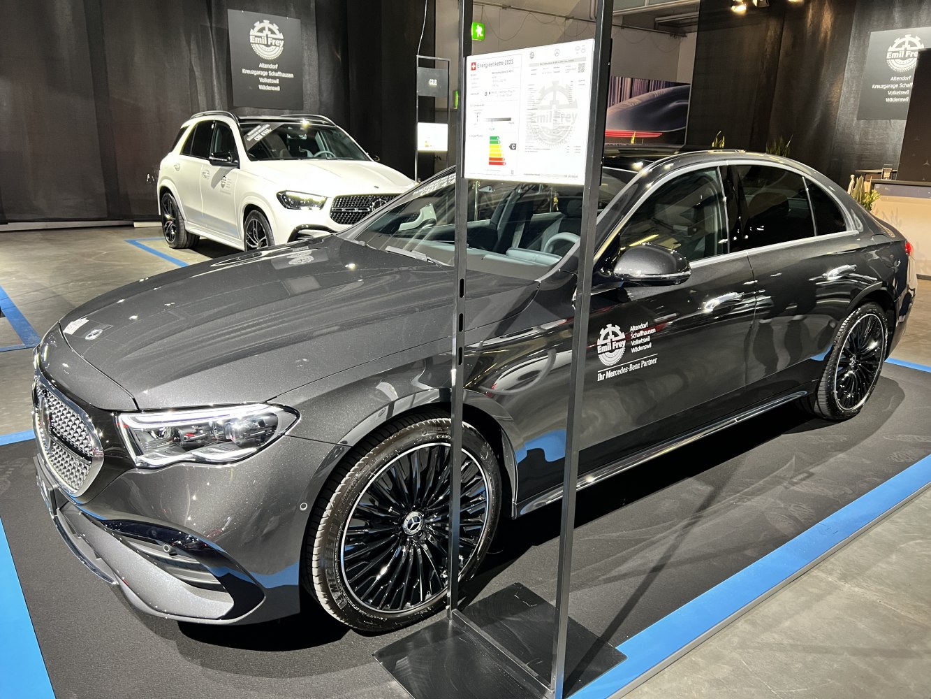 Front-side view of luxury sedan with black multi-spoke wheels